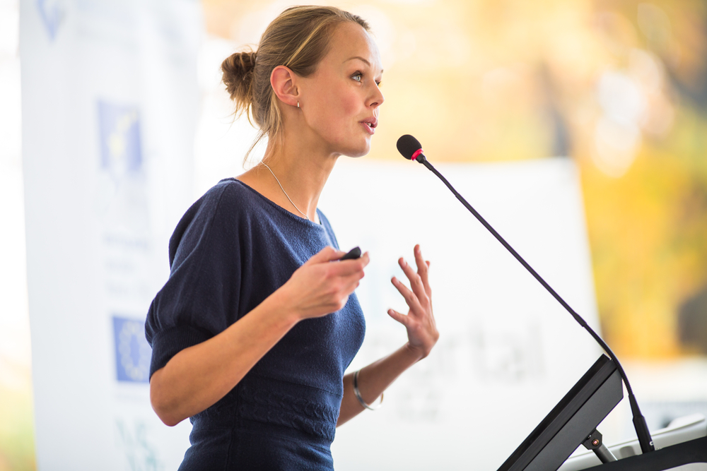 A woman presenting at a conference